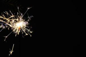 beautiful burning sparkler on christmas with black photo