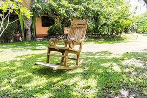 Empty rocking chair over grass photo