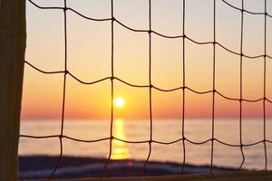 Beautiful colorful sunset over the sea and the sun shines. Orange sky. photo