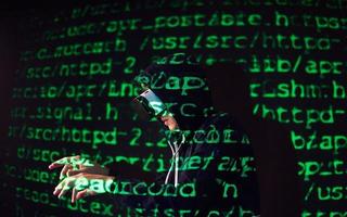 Double exposure of a caucasian man and Virtual reality headset is presumably a gamer or a hacker cracking the code into a secure network or server, with lines of code photo