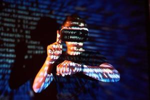 Double exposure of a caucasian man and Virtual reality headset is presumably a gamer or a hacker cracking the code into a secure network or server, with lines of code photo