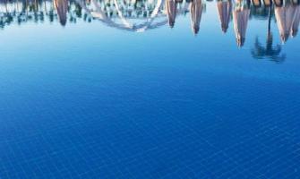 Clear blue water in the pool, through the sunlight. Water background photo