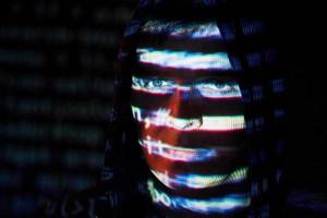 Cyber attack with unrecognizable hooded hacker using virtual reality, digital glitch effect photo