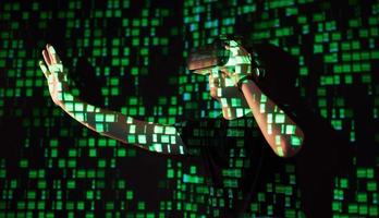 Double exposure of a caucasian man and Virtual reality headset is presumably a gamer or a hacker cracking the code into a secure network or server, with lines of code photo