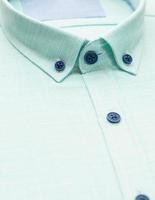 cotton shirt with a focus on the collar and button, closeup photo