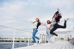 Happy jumping woman taking down the ground. photo