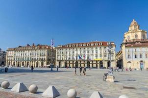 Turin, Italy, September 10, 2018 Old medieval buildings and baroque style San Lorenzo Saint Lawrence church on Castle Square Piazza Castello in historical centre of Torino city with clear blue sky photo