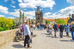 Prague, Czech Republic, May 13, 2019 street musicians are playing their instruments and people are walking photo