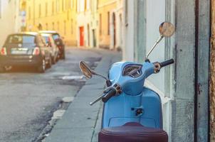 Brescia, Italy, September 11, 2019 Vintage blue scooter motorbike Vespa in narrow italian empty street