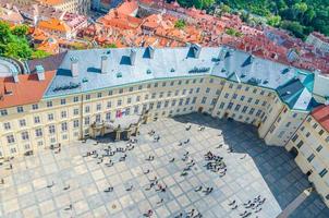 Top view of courtyard square of Prague Castle and Old Royal Palace with small figures