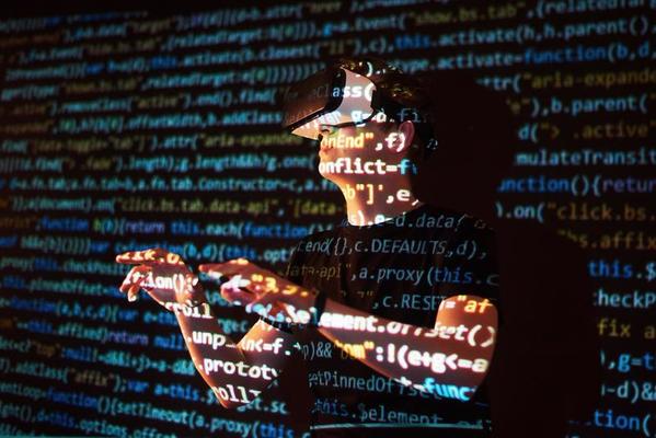 Double exposure of a caucasian man and Virtual reality headset is presumably a gamer or a hacker cracking the code into a secure network or server, with lines of code