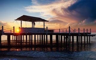 Wooden bridge pier against a beautiful sky measure used for natural background, background and multi-stage sea. photo