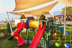 Colorful playground in the yard in the park at sunset. photo