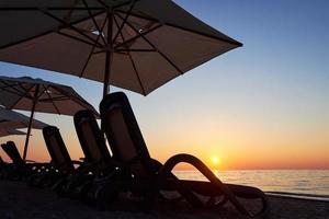 Scenic view of sandy beach on the beach with sun beds and umbrellas open against the sea and mountains. Hotel. Resort. Tekirova-Kemer photo