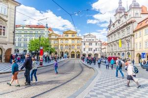 Prague, Czech Republic, May 13, 2019 people are walking crossing tram tracks on Malostranske namesti square photo