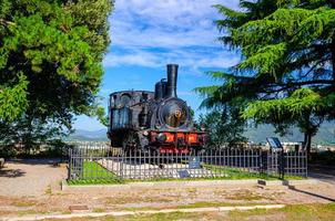 Brescia, Italy, September 11, 2019 Locomotiva a vapore SNFT - N.1 steam locomotive Prisoner monument photo