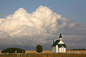 Thunderhead clouds forming behind a country church photo