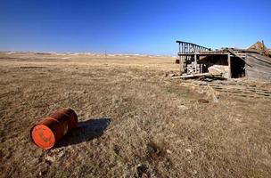 Old Barrell and Abandoned Car in Field photo