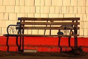 Old bench against shingle wall photo