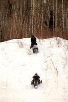 Two people out for a skidoo ride photo