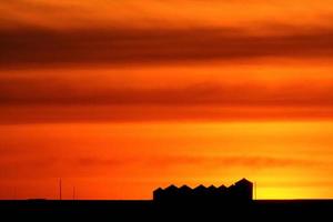 Set sun backlighting farm buildings photo