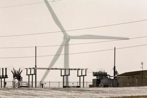 Windmill electrical generator by power station photo