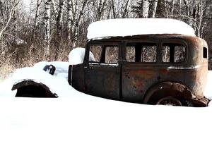 Snow covered antique automobiles