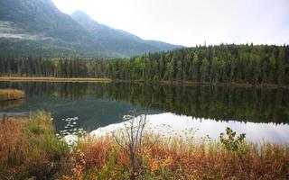 Reflections on a mountain lake in British Columbia photo