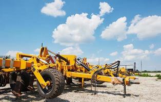 Close up of seeder attached to tractor in field. Agricultural machinery for spring works sowing photo