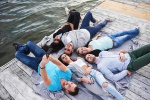 Group of happy beautiful young people who are doing Village on the pier, the best friends of girls and boys with the notion of pleasure creates emotional lives photo