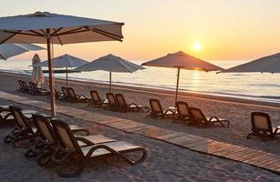 Scenic view of sandy beach on the beach with sun beds and umbrellas open against the sea and mountains. Hotel. Resort. Tekirova-Kemer photo