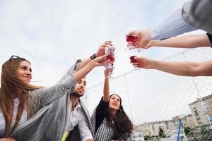 Clinking glasses with alcohol and toasting, party photo