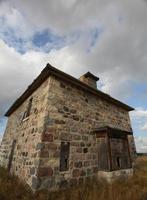 Abandoned stone house in scenic Saskatchewan photo