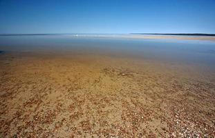 Sand flats along shore of Lake Winnipeg photo