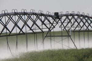 Water spinklers at work during cloudy day photo