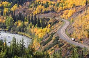 Autumn colored trees along mountain road in British Columbia photo
