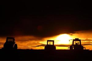 Sunrise behind farm machinery Saskatchewan photo