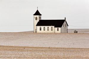 Lone country church on snow covered Prairies photo