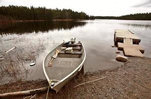 beached motor boat on Northern Manitoba lake photo