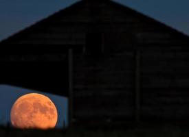 Full moon seen through old building window photo