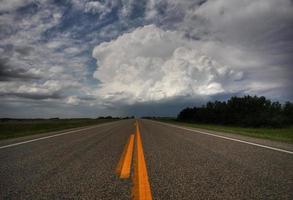 Storm clouds down a Saskatchewan highway photo