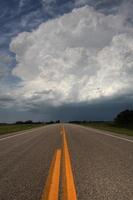 Storm clouds down a Saskatchewan highway photo