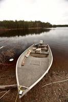 beached motor boat on Northern Manitoba lake photo