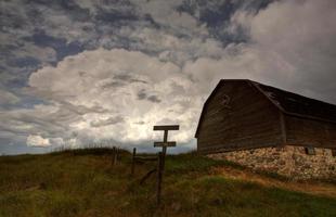 Storm clouds behind old Saskatchewan barn photo