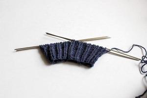 Yarn and knitting needles on white background. Handmade process photo