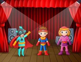 Children in super hero costumes performing on stage vector