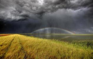 Storm clouds and rainbow over Chaplin Lake Marshes photo