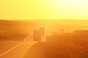 Semi trucks and sun glare along Trans Canada Highway photo