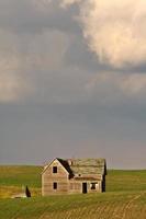 Storm clouds over Saskatchewan homestead photo