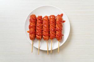 fried sausage skewer with ketchup photo